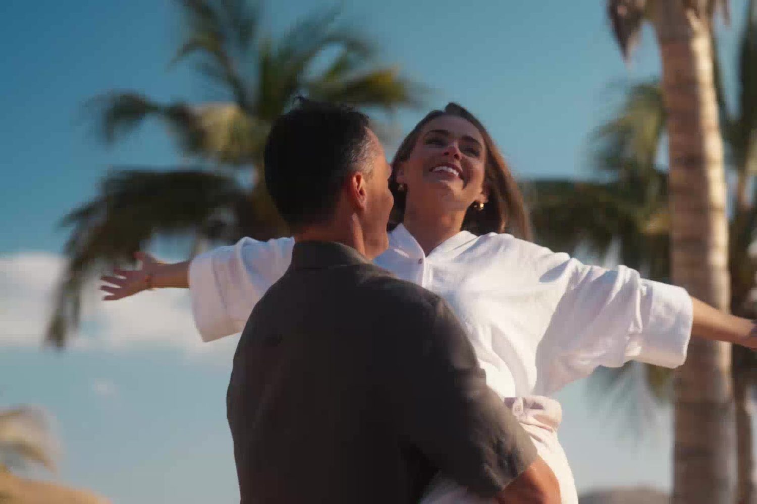Couple on the palm-lined beach at Muscat Bay