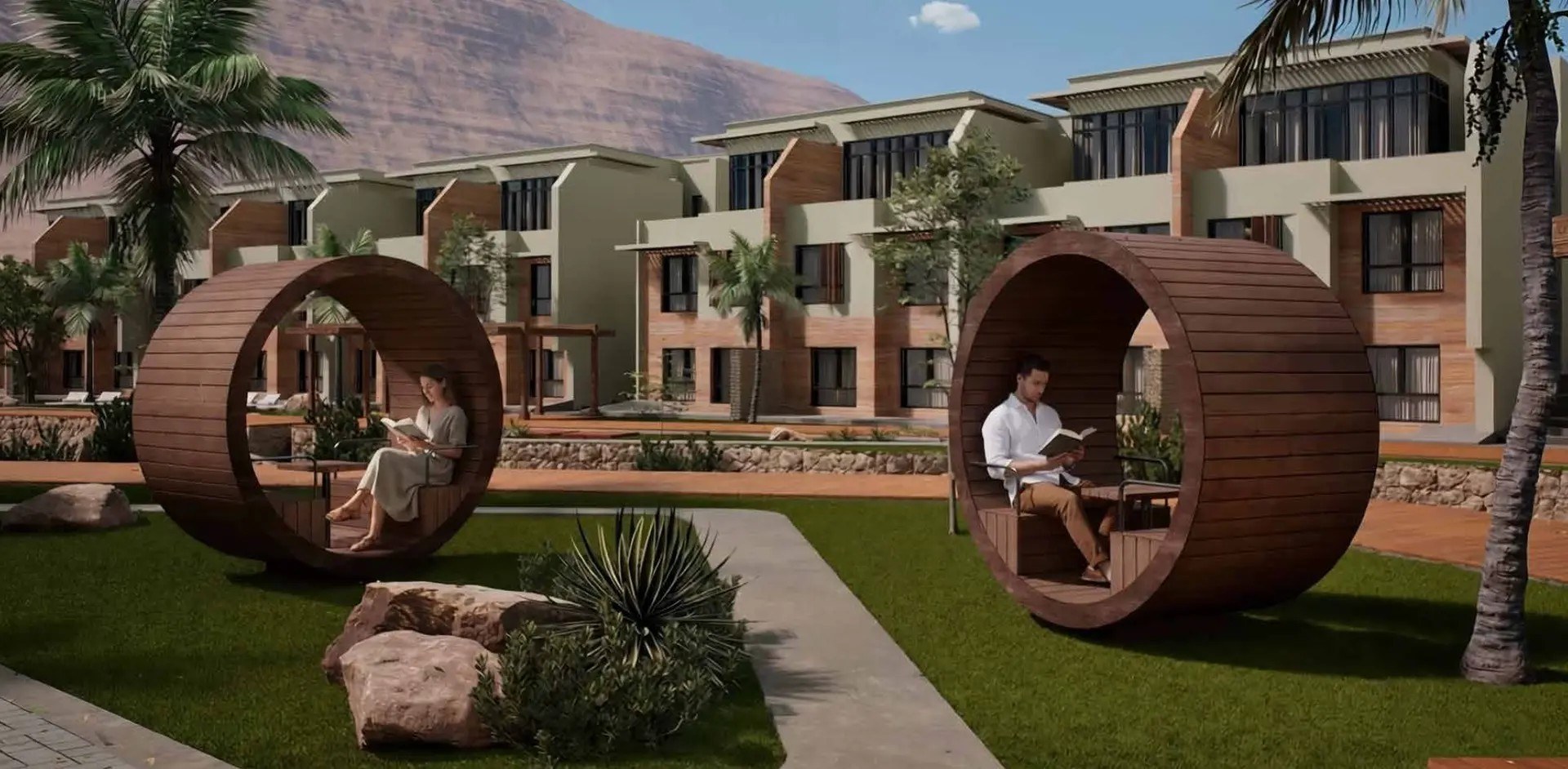 Luma Residences Muscat Bay — courtyard with wooden reading rings in front of the townhouses